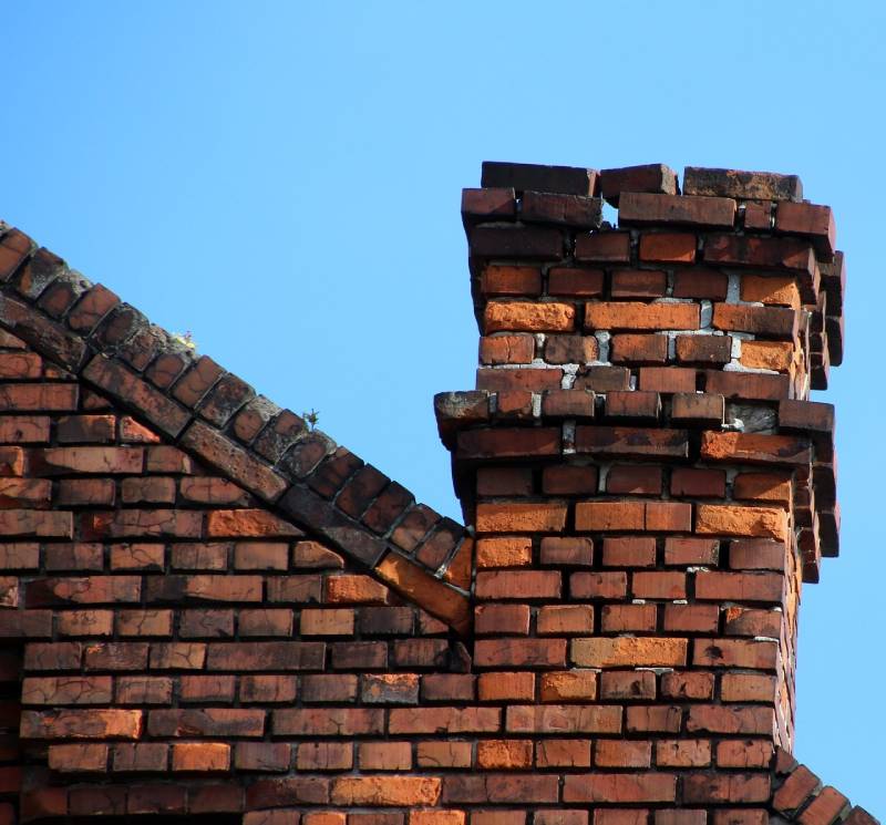Signs Your Long Grove Home Needs a Chimney Inspection Damaged chimney on an Long Grove home showing cracks and missing mortar